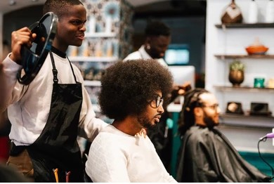 Professional barber giving a stylish haircut in a modern salon